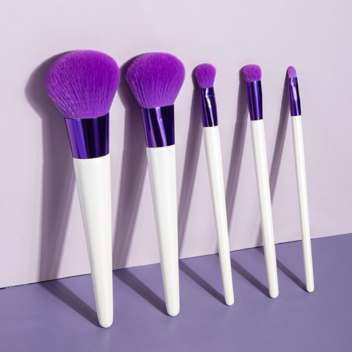 Makeup brush set with white handles and purple bristles